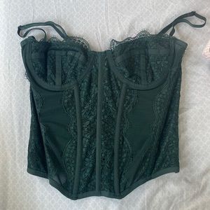 The Urban Outfitters corset top in green, size small.